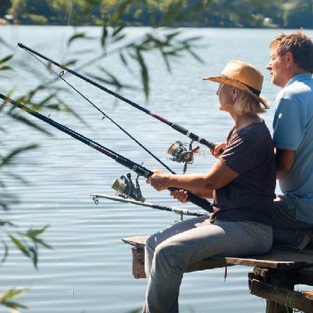 Retired couple fishing on lake | Pension tax 