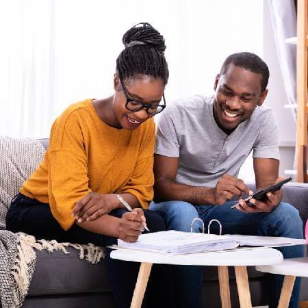 Couple checking their pension paperwork | maximise your long term savings