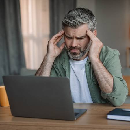 Man sitting at laptop looking confused | pension myths