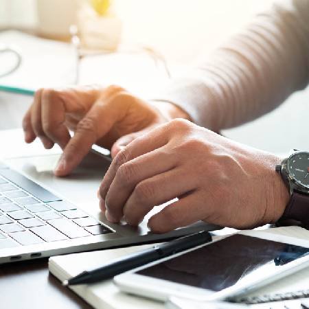 Man using laptop to locate lost pensions