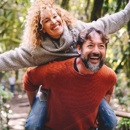 Couple in the woods enjoying early retirement