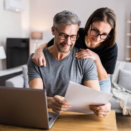 Couple looking at their joint bank statement | Budgeting tips to help with the cost-of-living