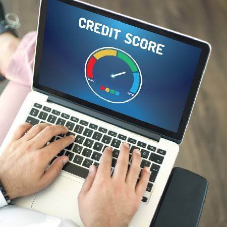 Man using laptop to check his credit score