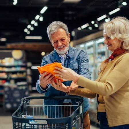 Older couple at the supermarket | saving on food shopping