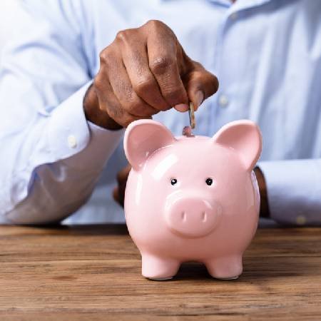 Saving pension money into a piggy bank during inflation 