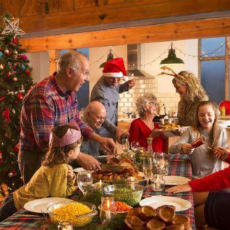 Multigenerational family at home eating Christmas dinner