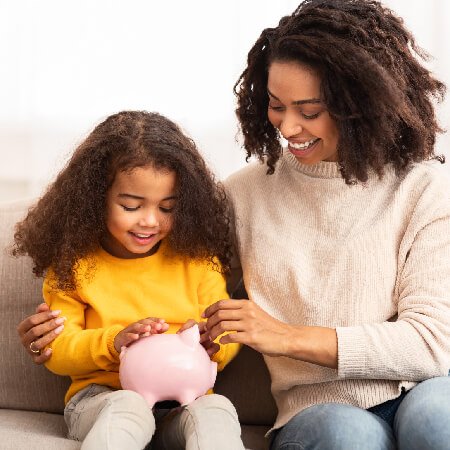 Mother and young daughter holding piggy bank | pension contributions