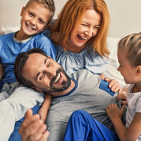 Young family laughing | Reasons parents help their children