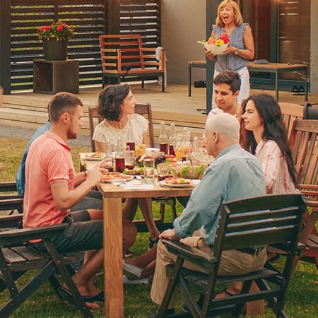 Family enjoying dinner together in the garden | Your pension and future plans