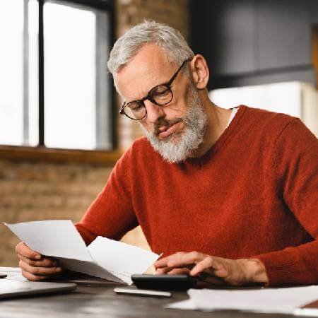 Middle aged man reviewing his retirement fund paperwork