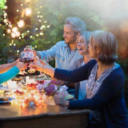 Friends smiling at a garden party | Generation X retirement