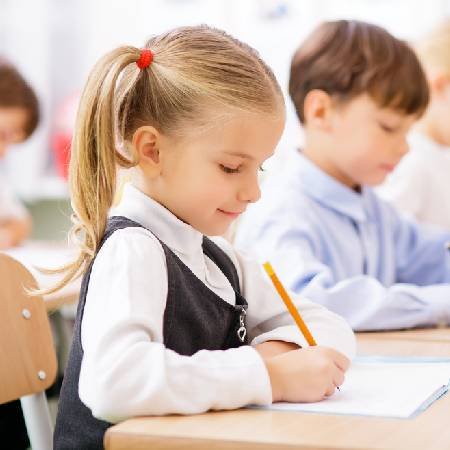 Young girl in the classroom at school | Children and money management