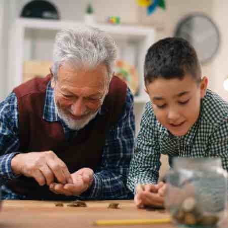 Grandad teaching grandson about money | Do your children need to understand pensions?