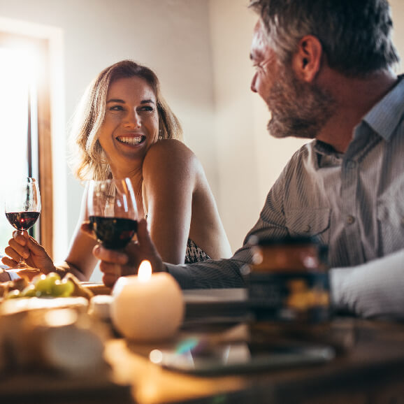 Couple smiling with a glass of red wine | Pension portfolio investments